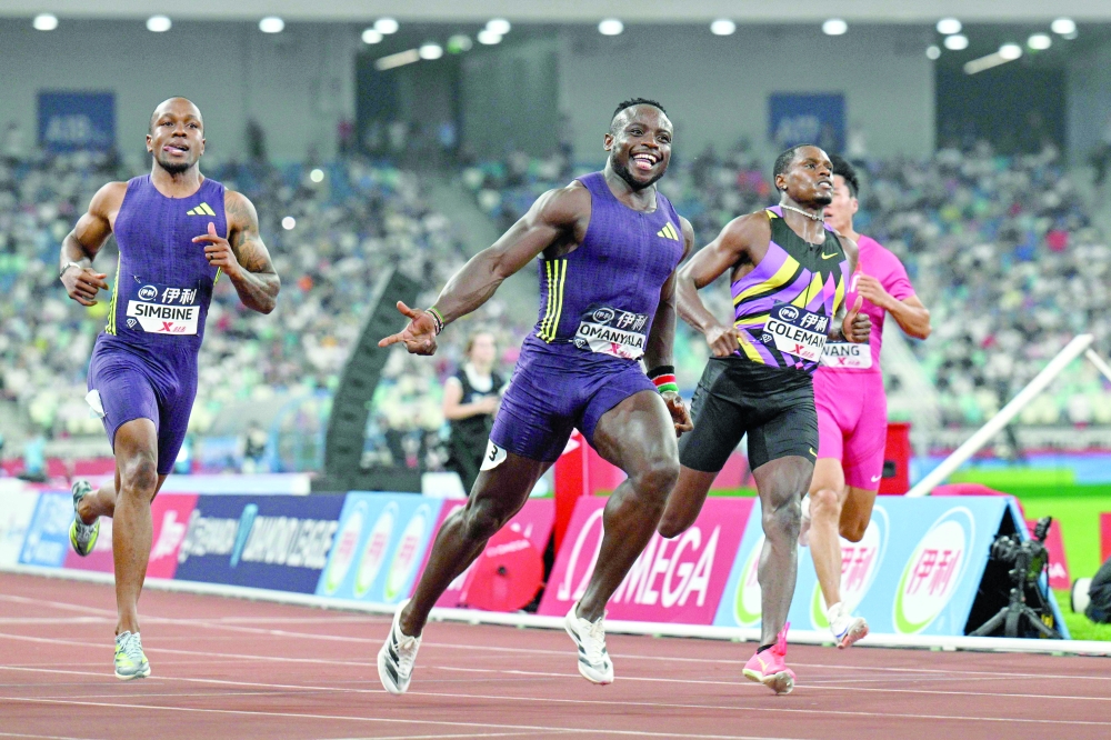 Kenya's Ferdinand Omanyala (C) reacts after crossing the finish line to win in the men's 100m event during the Diamond League Xiamen athletics meeting in Xiamen, in China’s southeast Fujian province on May 23, 2026.  (Photo by Hector RETAMAL / AFP)
