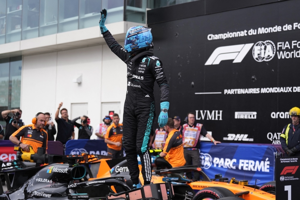  
Mercedes' George Russell celebrates after qualifying in pole position 