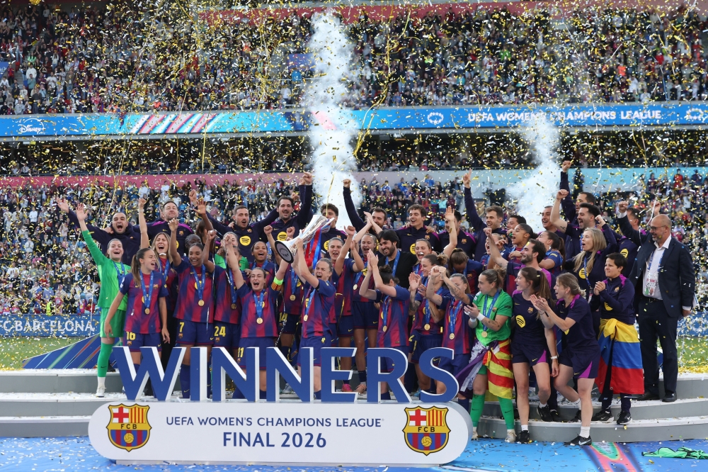  
FC Barcelona's Irene Paredes lifts the trophy as she celebrates winning the UEFA Women's Champions League with her teammates  