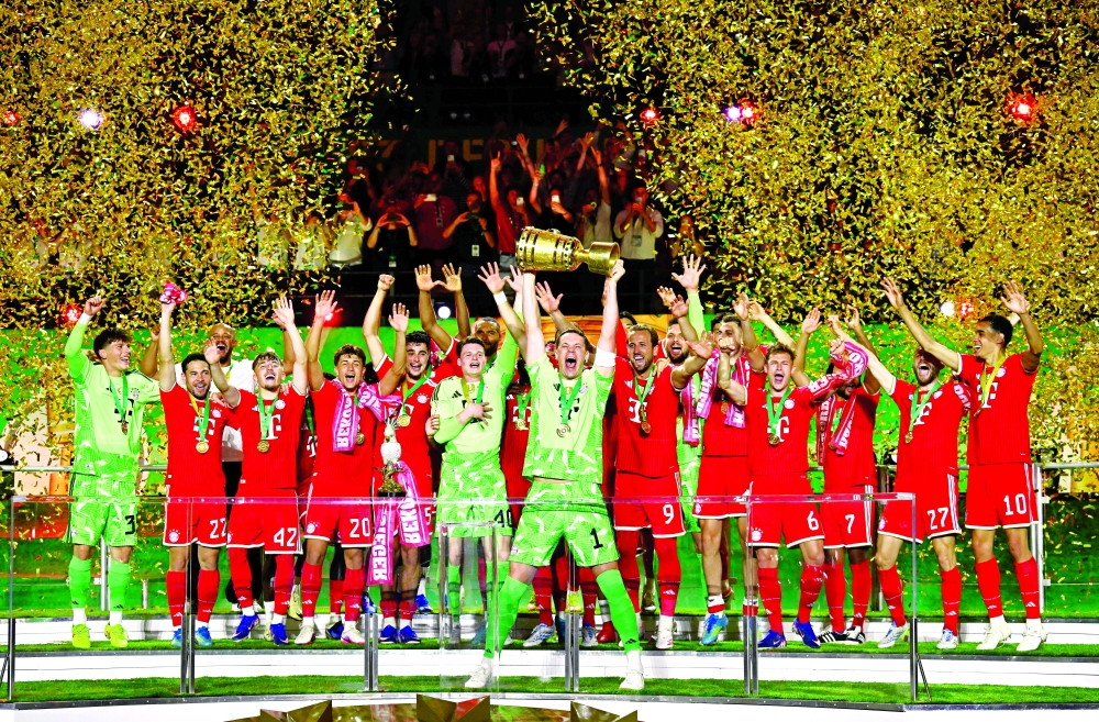 Manuel Neuer lifts the trophy after the German Cup. — AFP