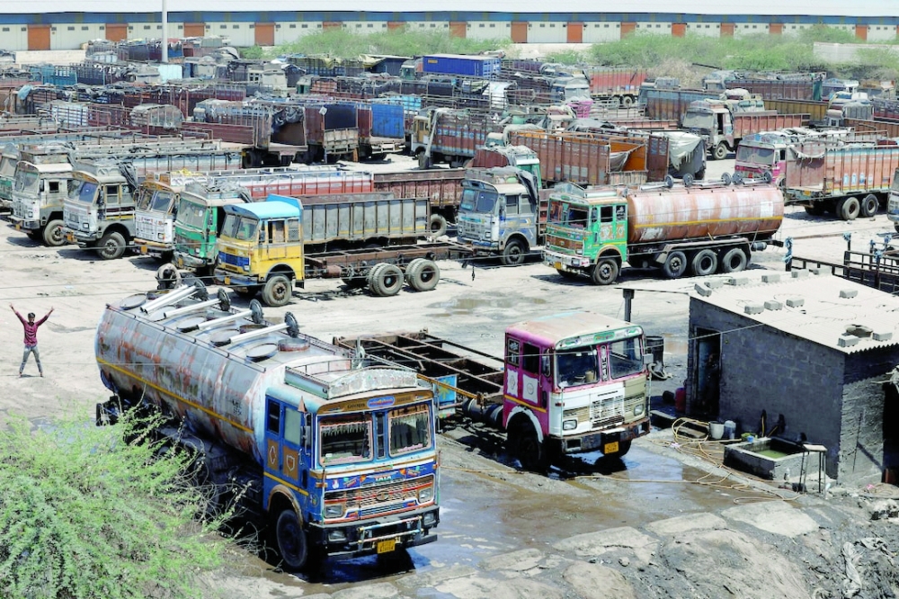 Trucks are parked at a parking area, as India faces rising oil prices following the closure of the Strait of Hormuz amidst the US-Israeli conflict with Iran, in Gandhidham, Gujarat, India. — Reuters