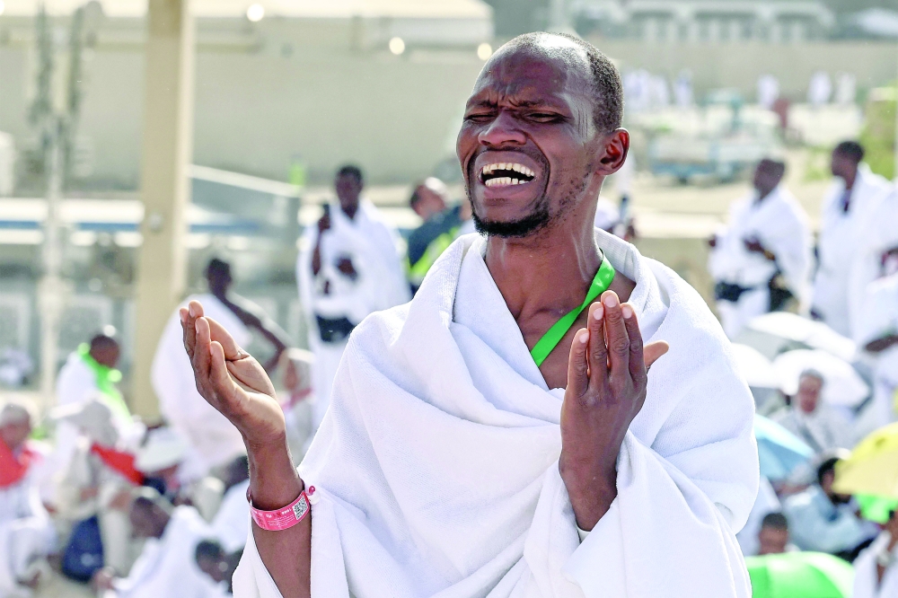 A Muslim pilgrim prays with others on Mount Arafat, also known as Jabal Al Rahma or Mount of Mercy, during the climax of the Haj pilgrimage early on Tuesday. - AFP