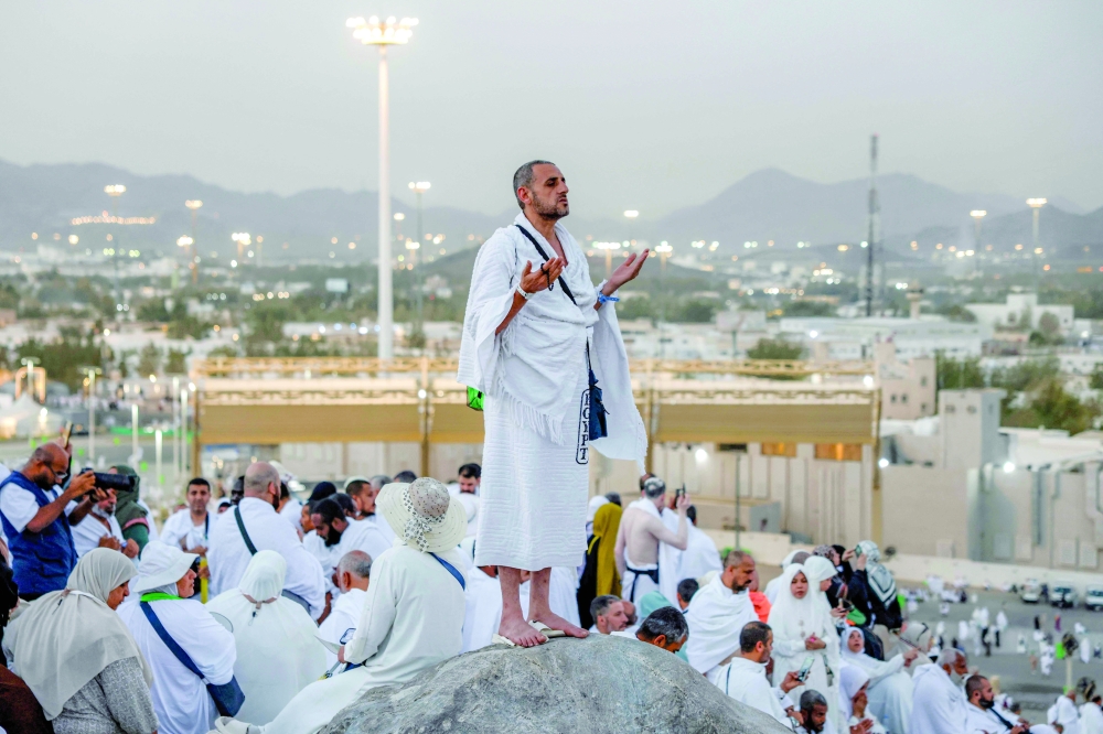 Muslim pilgrims pray on Mount Arafat. - AFP