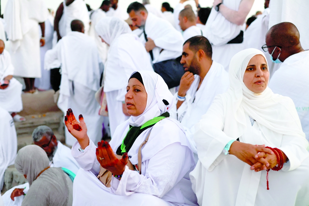 Muslim pilgrims gather at Mount of Mercy on the plain of Arafat as the sun rises during the annual Haj pilgrimage. - Reuters