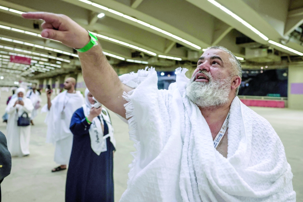 A pilgrim performs the symbolic 'stoning of the devil' ritual as part of the Haj pilgrimage in Mina on Wednesday. — AFP