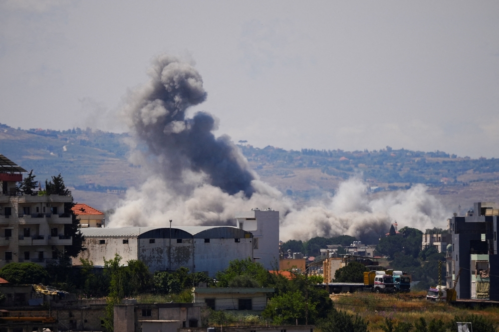 Smoke billows from southern Lebanon following Israeli strikes, as seen from Nabatieh, Lebanon May 28, 2026. 
