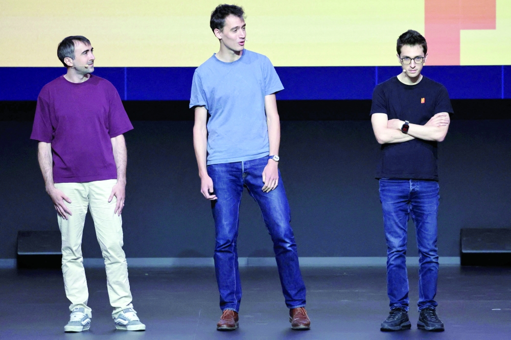French AI developer Mistral's co-founders: (from L) Chief Technical Officer Timothee Lacroix, CEO Arthur Mensch and Chief Science Officer Guillaume Lample address the opening keynote of Mistral's 'AI Now Summit' event at the Carrousel du Louvre in Paris. — AFP