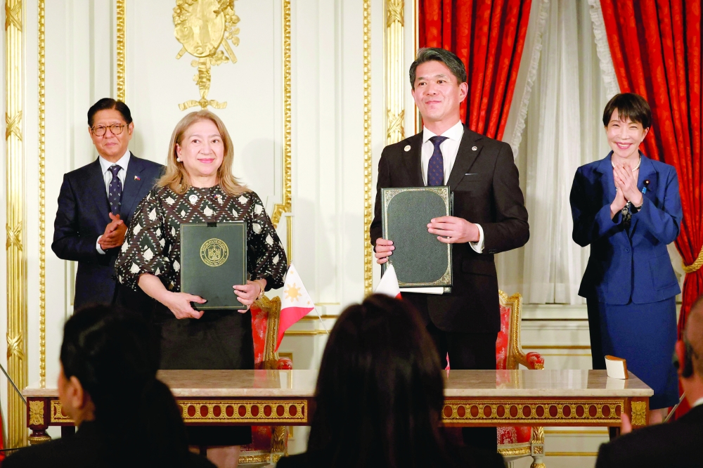 Philippines' President Ferdinand Marcos Jr and Japanese Prime Minister Sanae Takaichi applaud as Ambassador of the Philippines to Japan Mylene Garcia-Albano and Ambassador of Japan to the Philippines Kazuya Endo exchange documents during the Cooperation Document Exchange Ceremony at the Akasaka Palace State Guest House in Tokyo. — AFP