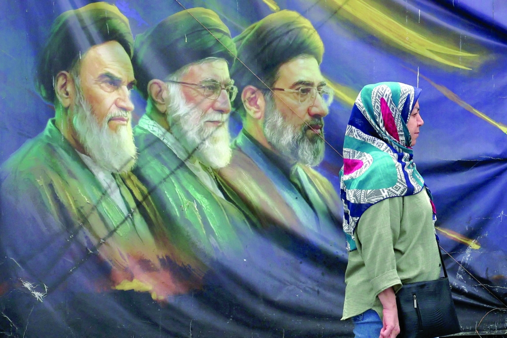 A billboard bearing the images of the late founder of the Islamic Revolution supreme leader Ayatollah Khomeini, the late Iranian supreme leader Ali Khamenei and his son, the current Supreme Leader Mojtaba Khamenei (R), erected along a street in Tehran. - AFP