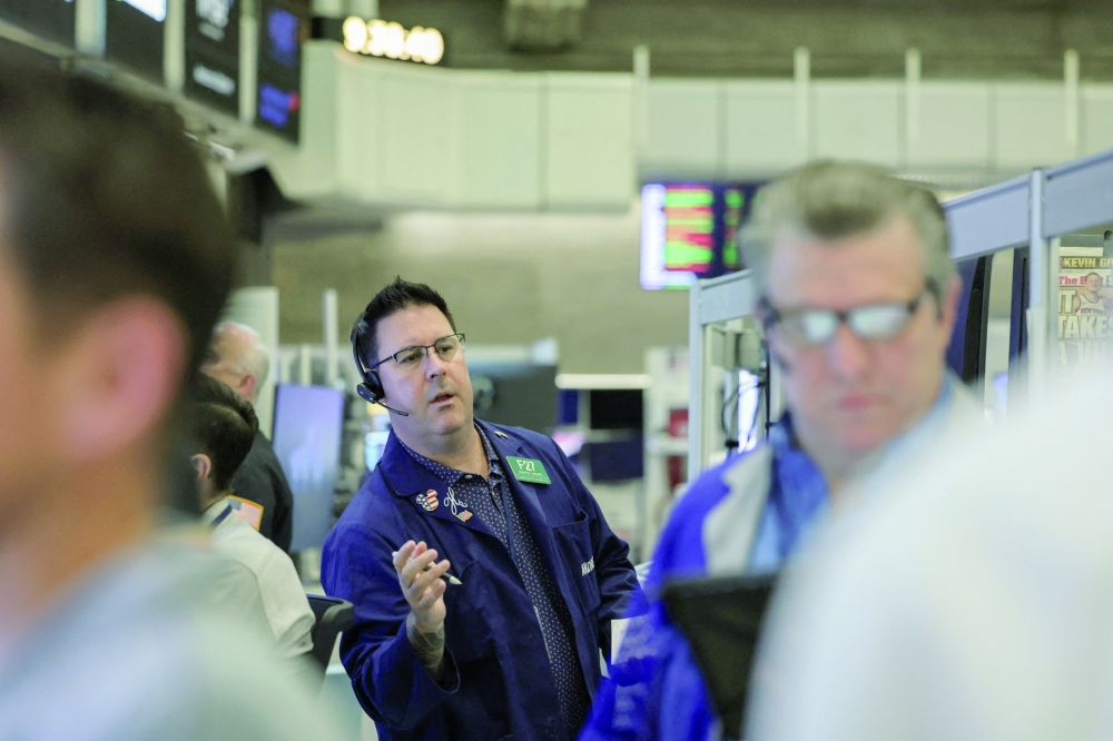 Futures-options traders work on the floor at the New York Stock Exchange's NYSE American (AMEX) in New York City. — Reuters