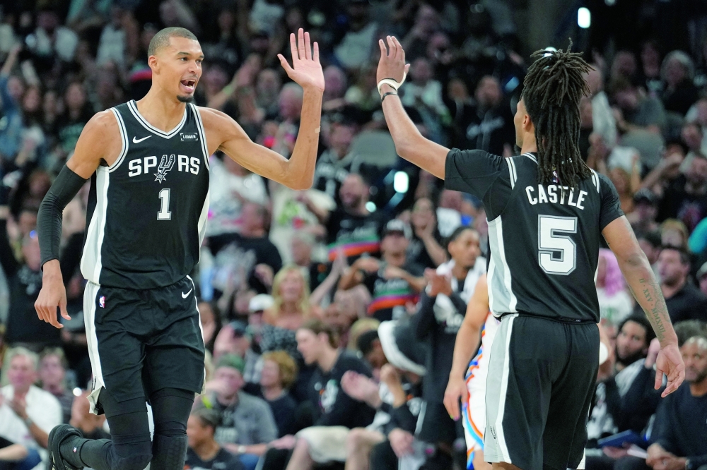 San Antonio Spurs' Victor Wembanyama (1) reacts with Stephon Castle (5) during game six of the western conference finals for the 2026 NBA playoffs at Frost Bank Center. — Imagn Images