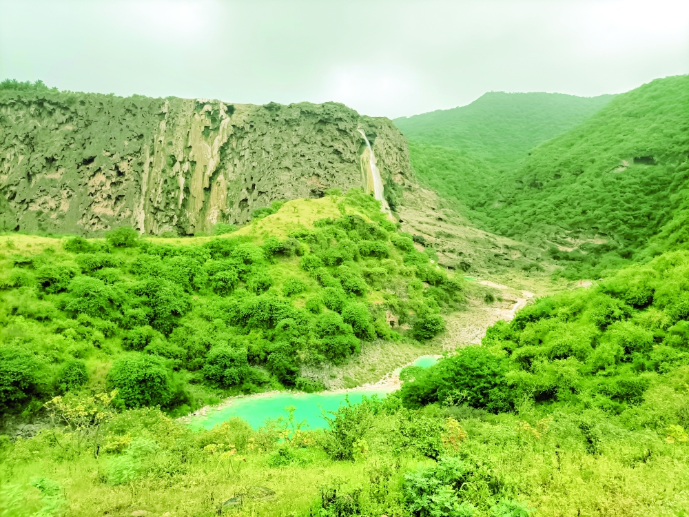 Wadi Darbat, known for its lush green landscapes and seasonal waterfalls
