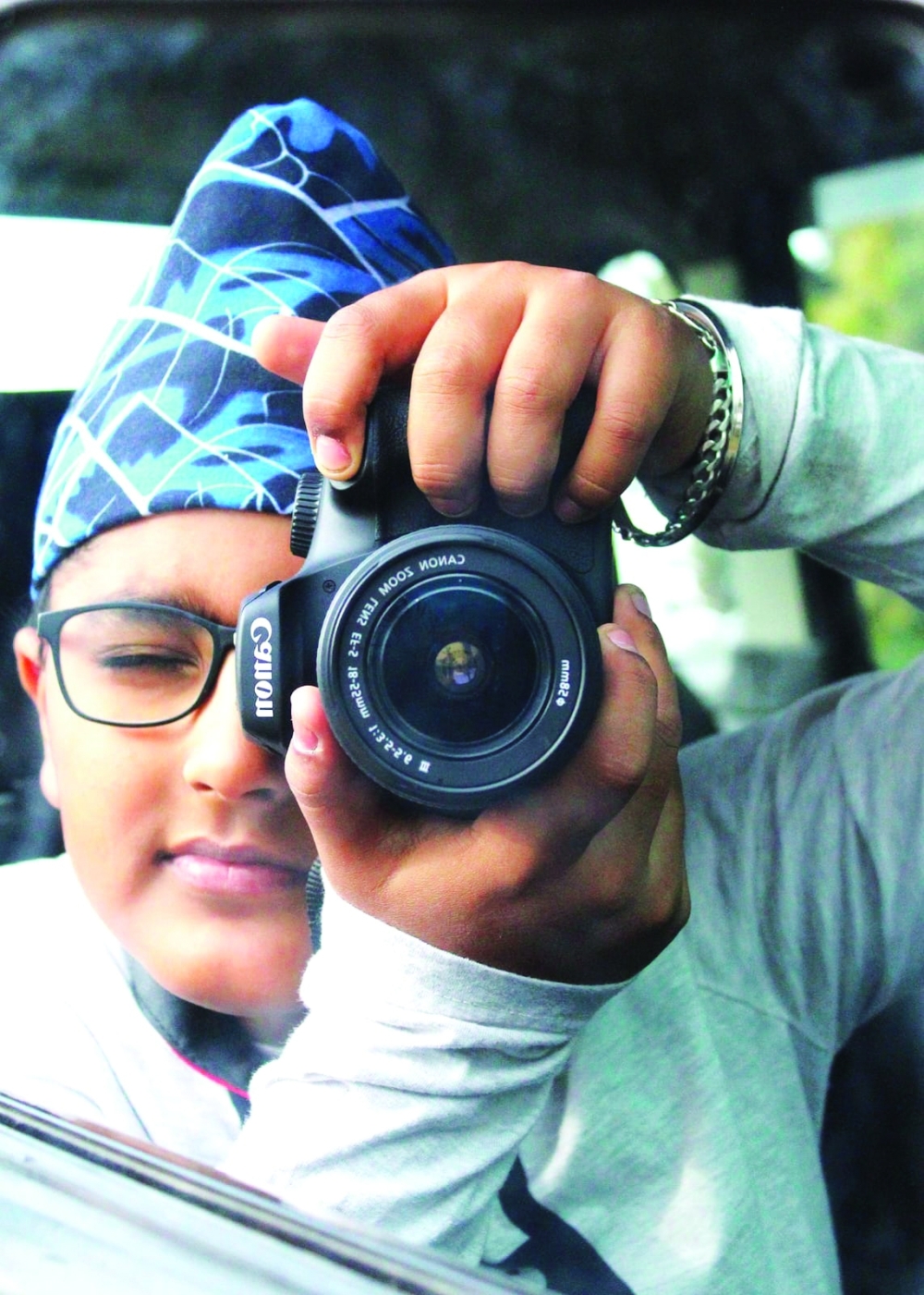 Young photographer Paramveer Singh with his camera