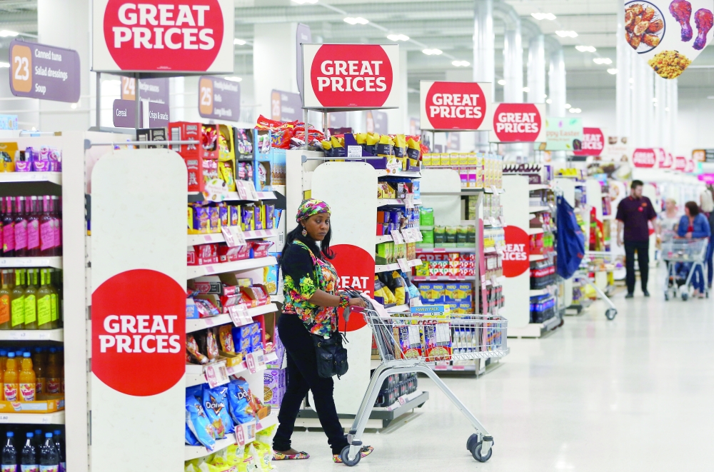 A shopper pushes a trolley in a supermarket in London. — Reuters