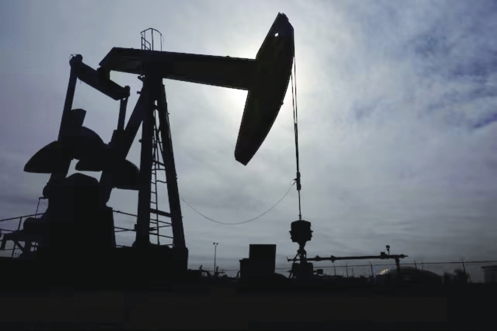 A pump jack operates near a crude oil reserve in the Permian Basin oil field near Midland, Texas. — Reuters