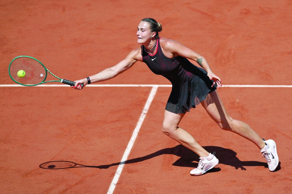Aryna Sabalenka plays a forehand return to Australia's Daria Kasatkina during their women's singles match on day 7 of the French Open tennis tournament on Court Suzanne-Lenglen at the Roland-Garros Complex in Paris on May 30, 2026. (Photo by Anne-Christine POUJOULAT / AFP)
