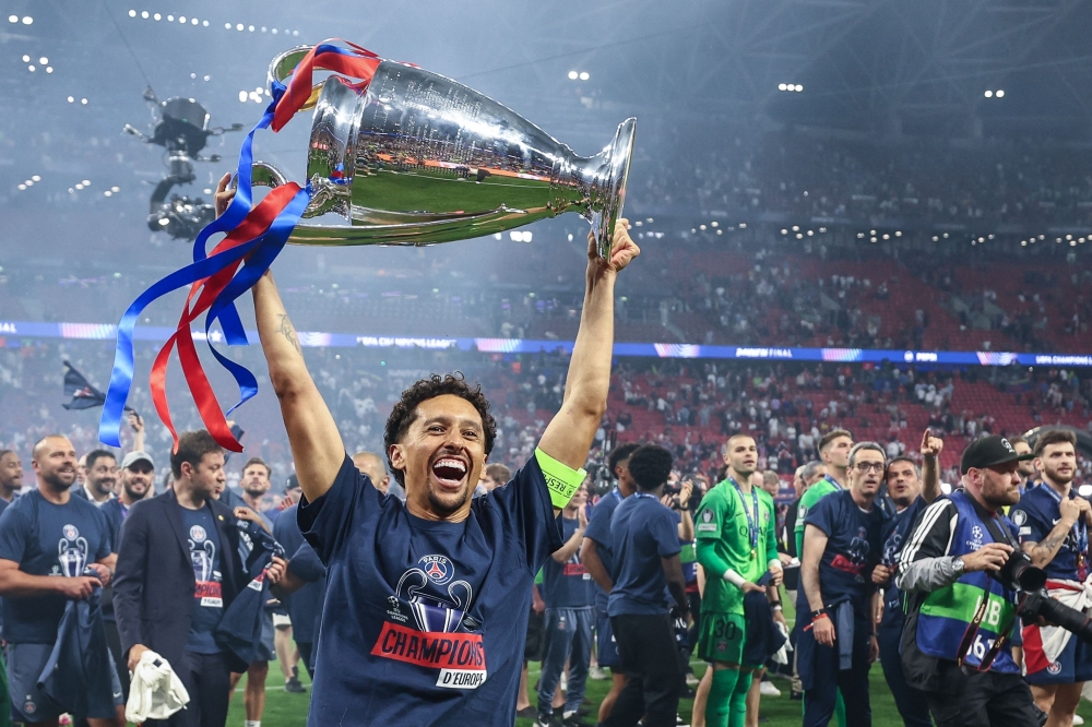   Paris Saint-Germain's Brazilian defender #05 Marquinhos celebrates with the trophy  