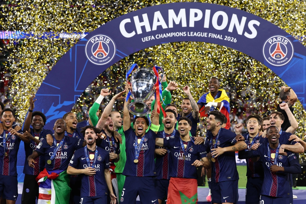 Paris Saint-Germain's Brazilian defender #05 Marquinhos lifts the trophy as he celebrates with teammates winning the UEFA Champions League  