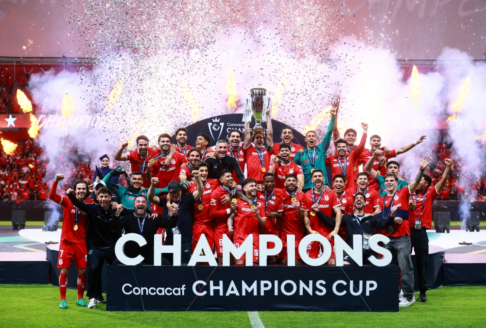  
Toluca players celebrate with the trophy after winning the CONCACAF Champions Cup  