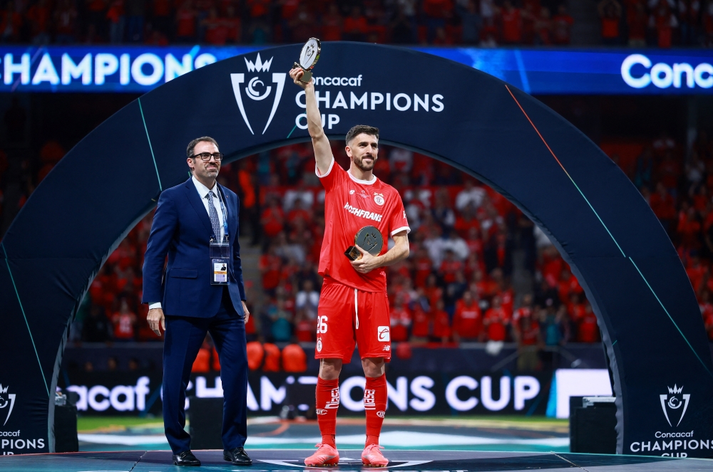  
Toluca's Paulinho celebrates after winning the CONCACAF Champions Cup  