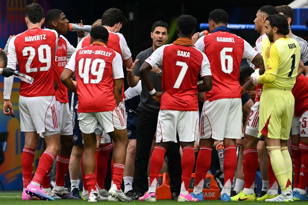 Arsenal's Spanish manager Mikel Arteta (C) speaks to his players 