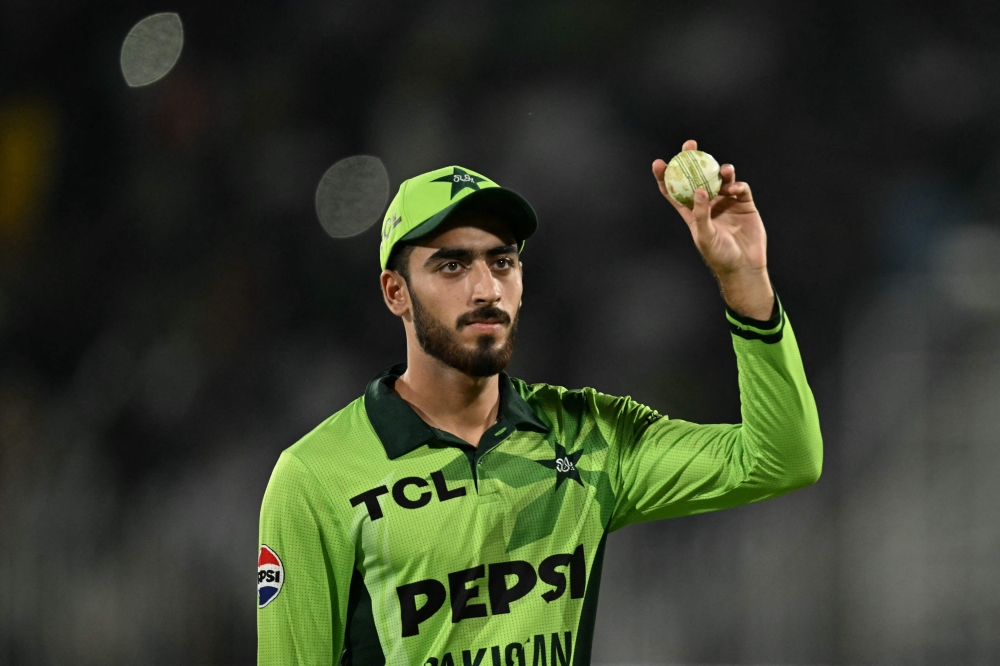 Pakistan's Arafat Minhas shows the ball after taking a five-wicket haul  