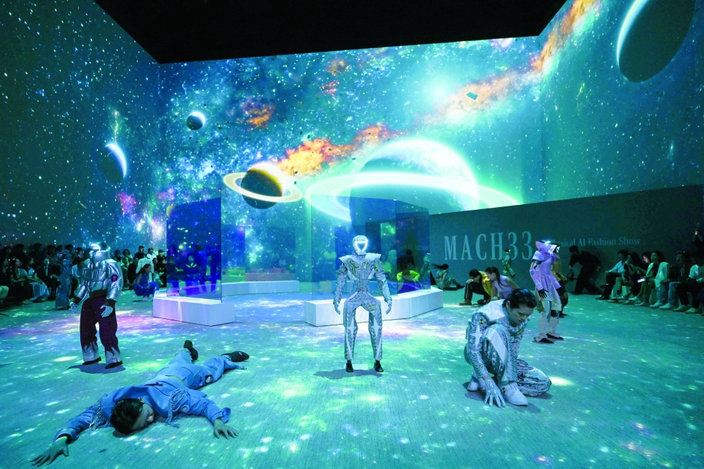 Humanoid robots and models perform as they present creations at Galaxy Corporation's "Mach33: Physical AI Fashion Show" in Seoul on May 28, 2026.  (Photo by Pedro PARDO / AFP)
