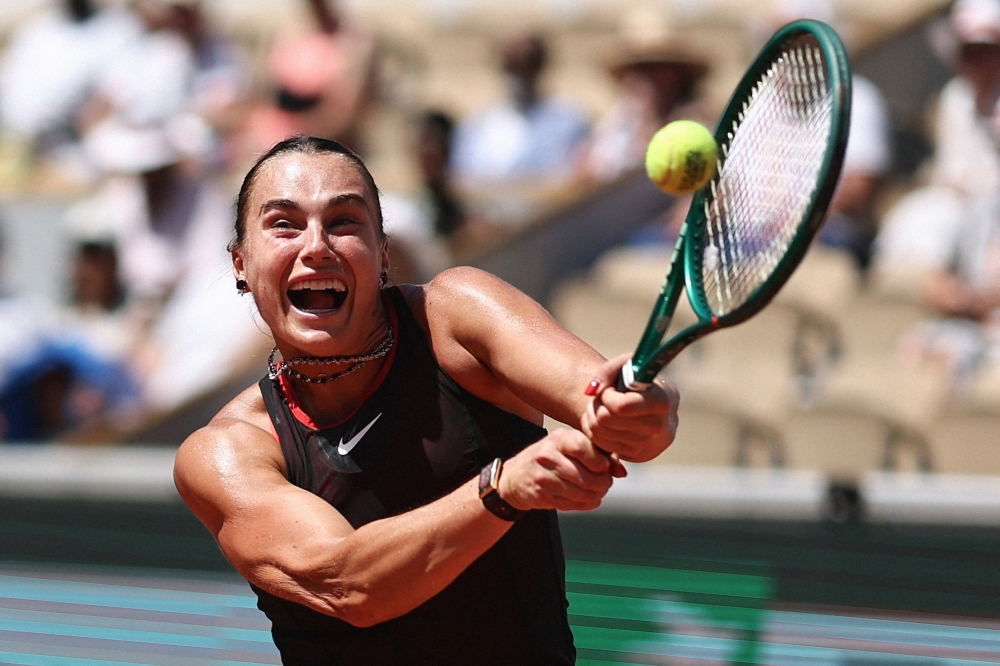 Aryna Sabalenka plays a backhand return to Australia's Daria Kasatkina 