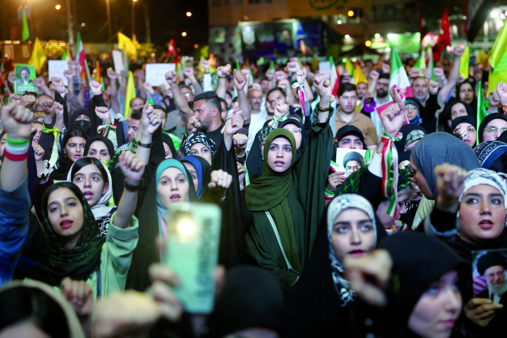 People chant during a rally in Tehran, Iran. — Reuters 