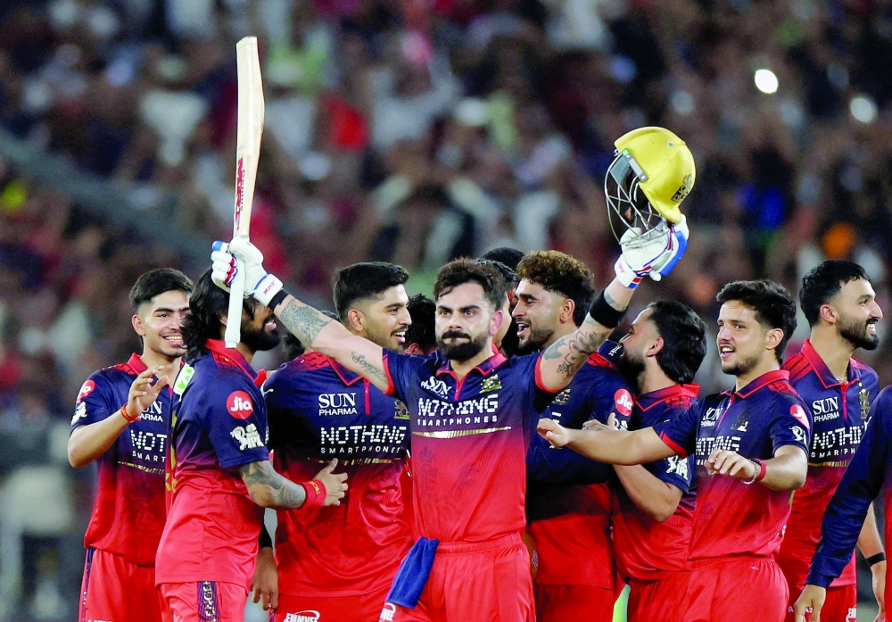 Royal Challengers Bengaluru's Virat Kohli celebrates with teammates after winning the Indian Premier League. — Reuters