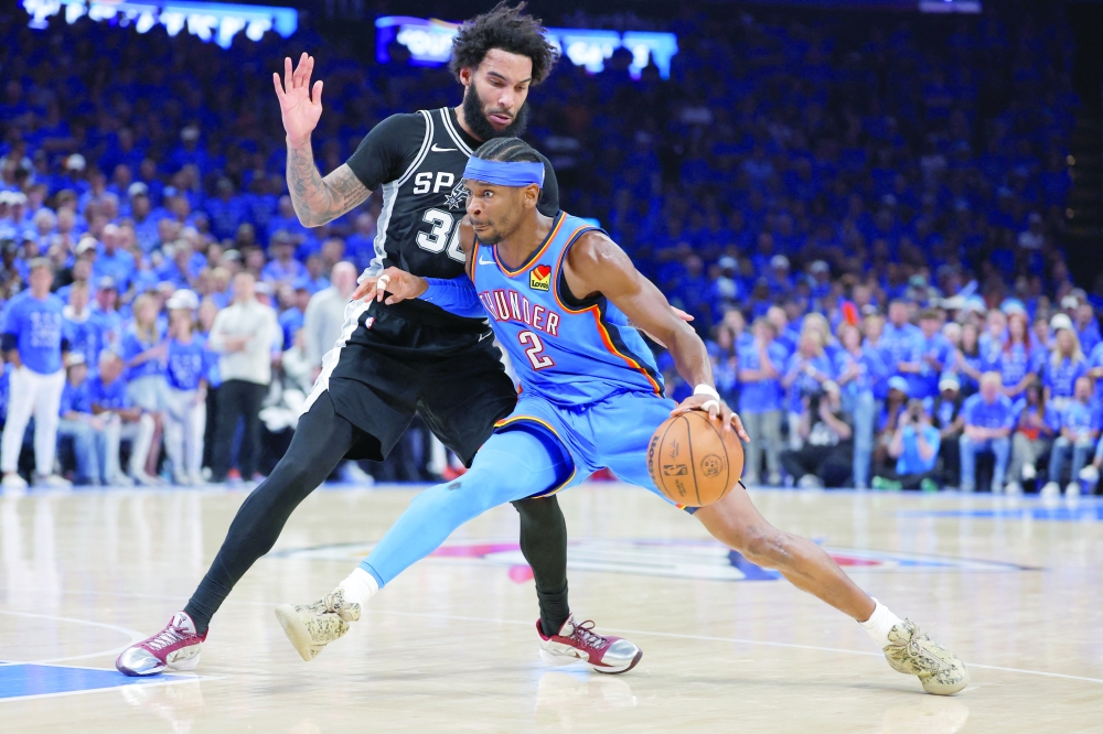 Oklahoma City Thunder's Shai Gilgeous-Alexander (2) controls the ball against San Antonio Spurs' Julian Champagnie (30) during game seven of the western conference finals for the 2026 NBA playoffs at Paycom Center. — Imagn Images