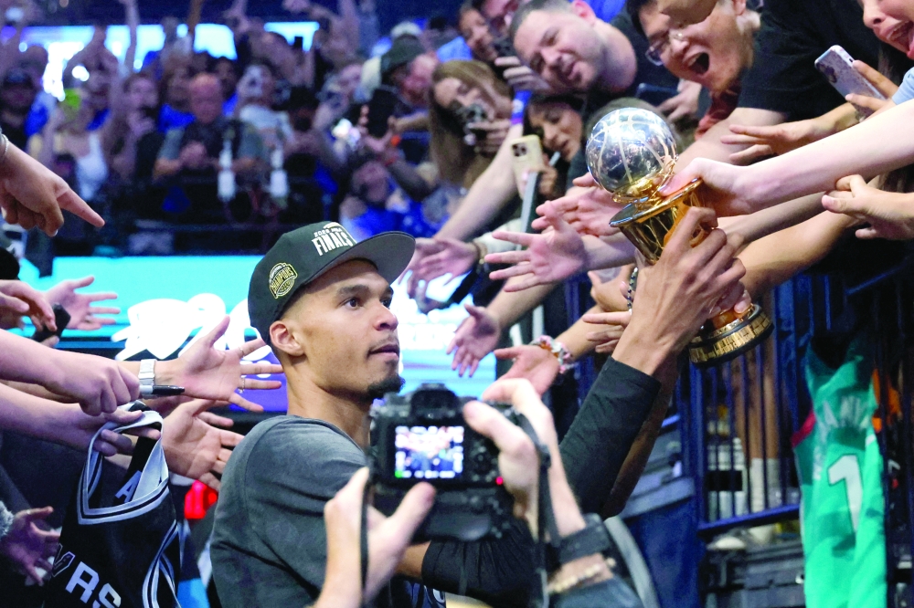 San Antonio Spurs' Victor Wembanyama (1) celebrates with the MVP trophy after defeating the Oklahoma City Thunder in game seven of the western conference finals for the 2026 NBA playoffs at Paycom Center. — Imagn Images