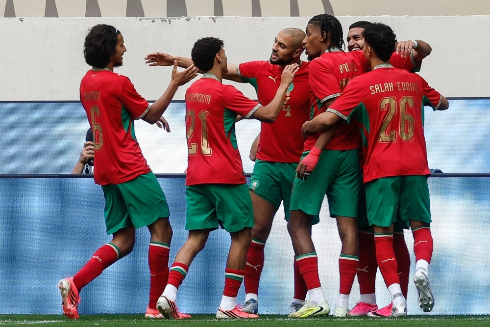 Morocco's players celebrate after Morocco's #11 Ismael Saibari (back R) scored his teams' first goal  
