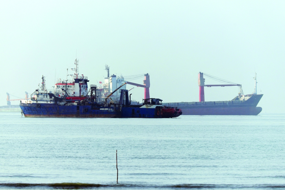 Vessels in the Strait of Hormuz are visible near the beach of Bandar Abbas, Iran. — Reuters 