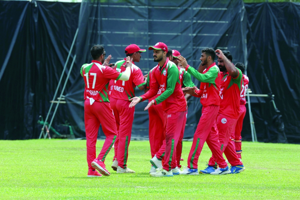 Oman team players celebrate during the match.