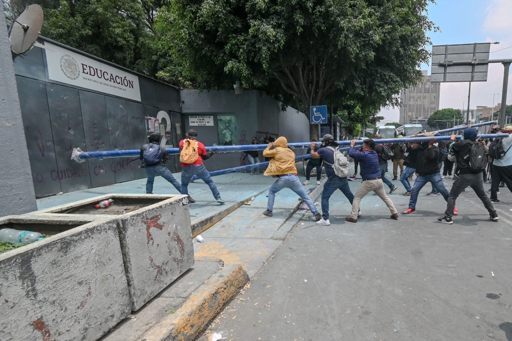 Protesters break into the Ministry of Education during a demonstration by the National Coordination of Education Workers (CNTE) in Mexico  