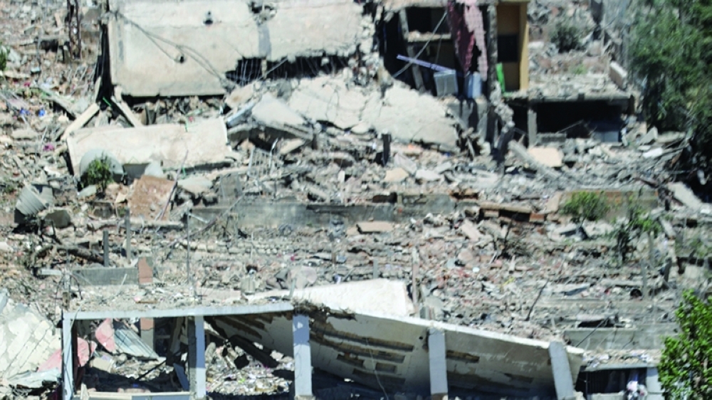 Machinery operates, as the Lebanese army opens a road, past buildings destroyed during the Israeli military campaign, in Dibbin, southern Lebanon June 4, 2026. REUTERS/Stringer 