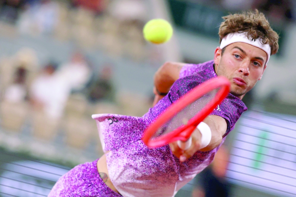 Italy's Flavio Cobolli plays a backhand return to Canada's Felix Auger-Aliassime during their men's quarter final singles match 