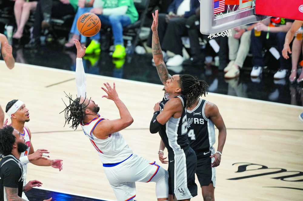 New York Knicks' Jalen Brunson (11) shoots the ball over San Antonio Spurs' Devin Vassell (24) during game one of the 2026 NBA Finals 
