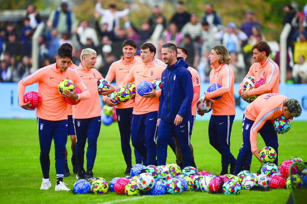 Uruguay's (L-R) defender Guillermo Varela, forward Brian Rodriguez, forward Rodrigo Aguirre and defender Mathias Olivera take part in a farewell activity with children ahead of the departure of the squad for the Fifa World Cup 2026
