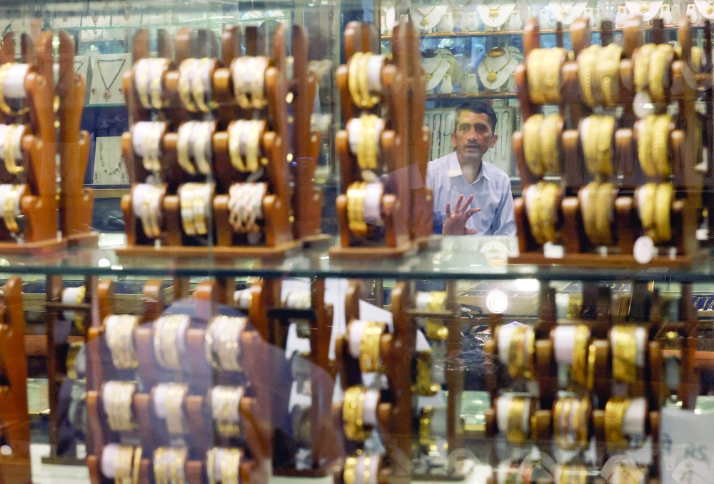 A salesperson talks to a customer at a jewellery shop in the old quarters of Delhi