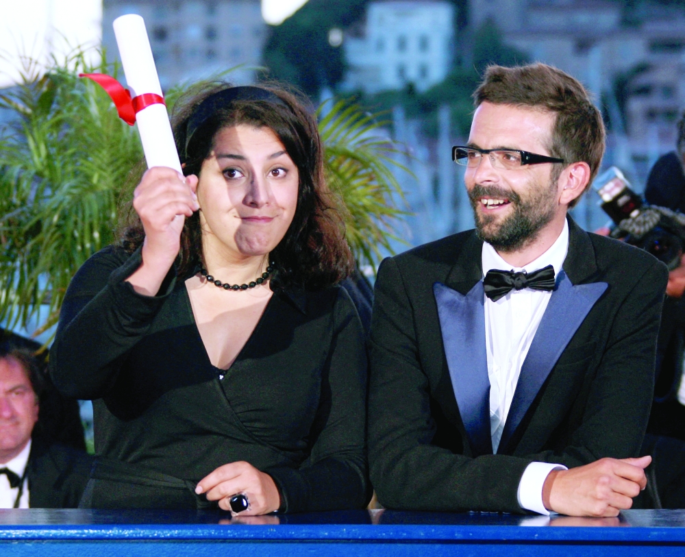 Iranian cartoonist Marjane Satrapi and French director Vincent Paronnaud attend a photocall at the 60th Cannes Film Festival at the Festival Palace in Cannes