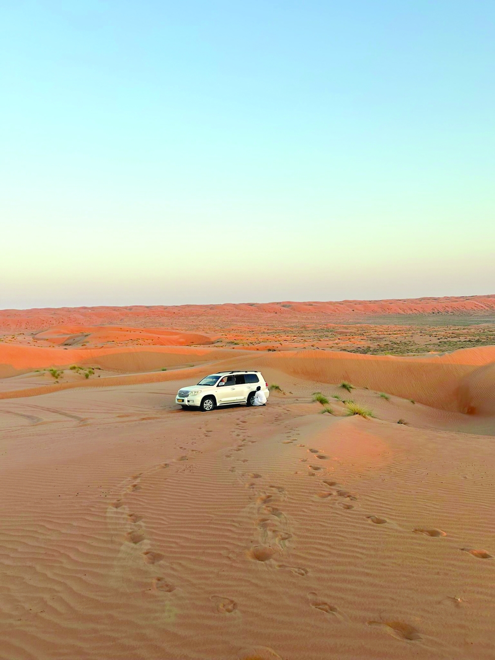 Tourists cross Rimal Al Sharqiya