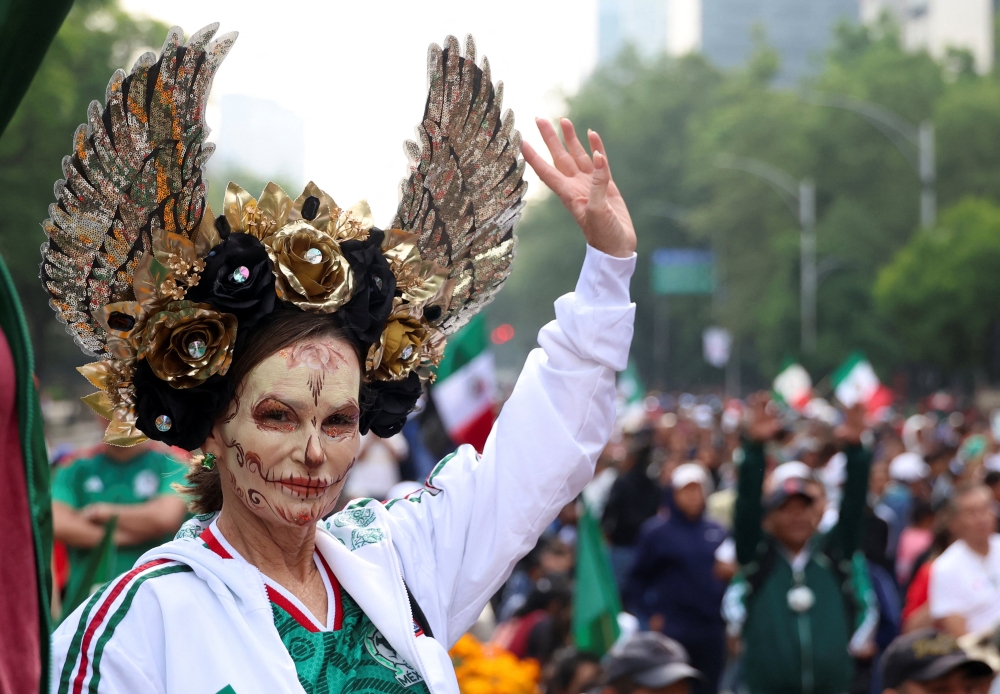 People participate in an attempt to break the Guinness World Record for the world’s largest "Mexican wave” 