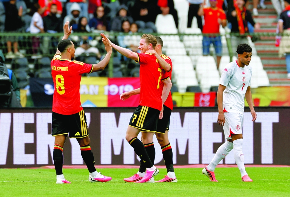 Belgium's Kevin De Bruyne celebrates scoring their third goal with teammates