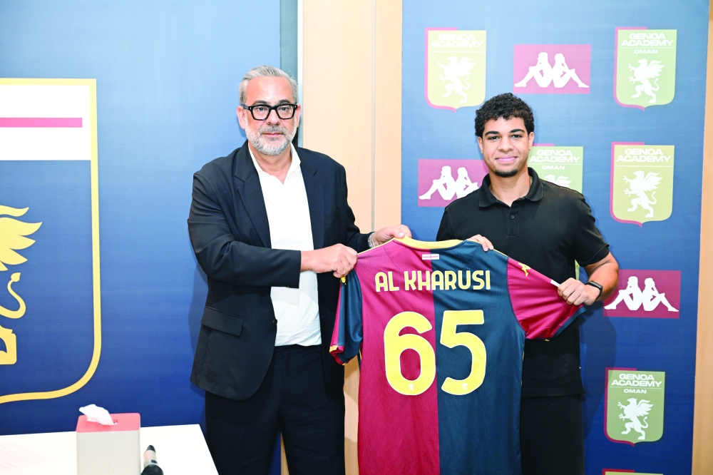 Genoa CFC officials with Suhaib al Kharousi during the signing ceremony. — Abdulwahid al Hamadani 