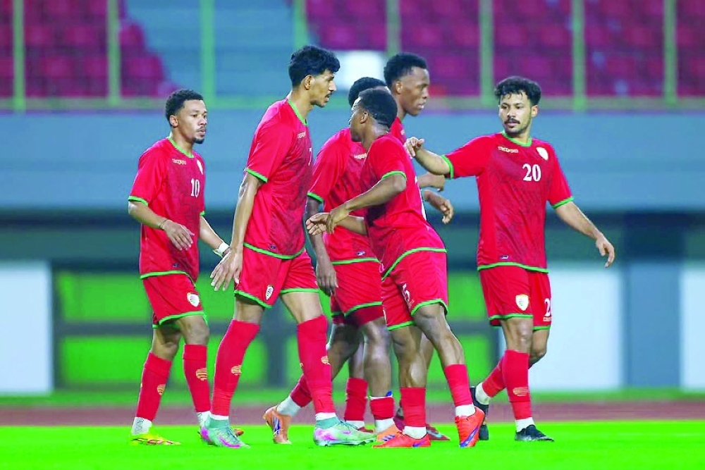 Oman players celebrate during their 4-1 friendly win over Mozambique in Jakarta.