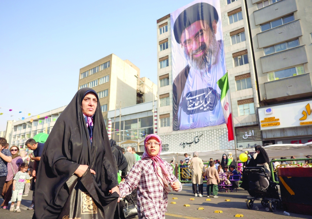 Iranians take part during a rally in support of the country's supreme leader Mojtaba Khamenei 