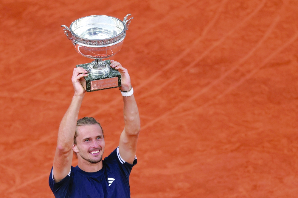 Germany's Alexander Zverev lifts "La Coupe des Mousquetaires" trophy after winning the men's final. — AFP