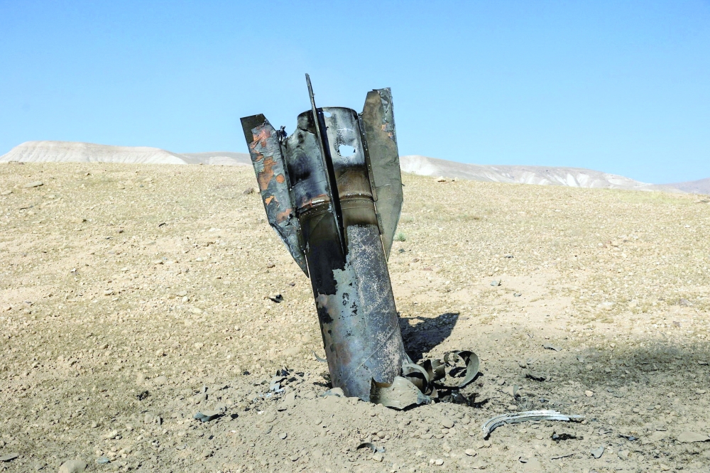 Part of a missile protrudes from the ground, following strikes from Iran, in the central Israeli-occupied West Bank. — Reuters 